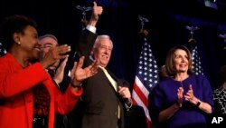 House Minority Leader Nancy Pelosi of Calif., right, steps away from the podium as House Minority Whip Steny Hoyer, D-Md., makes