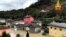 A firefighters' helicopter flies over flooding in the town of Ornavasso, in the northern Italian region of Piedmont, Oct. 4, 2020.