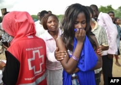 Students evacuated from Moi University during a terrorist seige react as they gather together in Garissa, Kenya, before being transported to their home regions, April 3, 2015.