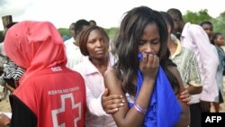 Students evacuated from Moi University during a terrorist seige react as they gather together in Garissa, Kenya, before being transported to their home regions, April 3, 2015.