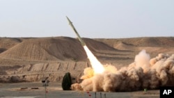This file photo released on Wednesday, Aug. 25, 2010, by the Iranian Defense Ministry, claims to show the launch of the Fateh-110 short-range surface-to-surface missile by Iranian armed forces, at an undisclosed location. 