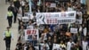 Demonstrators march during a protest over the disappearance of booksellers in Hong Kong, Jan. 10, 2016. The banner reads, in part: "Against political kidnapping. ... Demanding the immediate release of the five people from Causeway Bay Books."