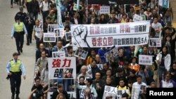 Demonstrators march during a protest over the disappearance of booksellers in Hong Kong, Jan. 10, 2016. The banner reads, in part: "Against political kidnapping. ... Demanding the immediate release of the five people from Causeway Bay Books."