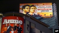 A banner for Sony Pictures' "The Interview," a film whose release was recently canceled, is posted high outside Arclight Cinemas in Hollywood, California, Dec. 17, 2014.