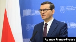 Poland's Prime Minister Mateusz Morawiecki addresses a joint press conference with Lithuania's Prime Minister on the migrant crisis on the Polish border with Belarus, in Vilnius, Nov. 21, 2021.