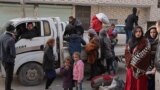 Syrians flee their homes in the Ghwayran neighborhood in the northern city of Hasakeh on Jan. 23, 2022, on the fourth day of fighting between the Kurdish forces and Islamic State (IS) group fighters.