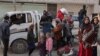 Syrians flee their homes in the Ghwayran neighborhood in the northern city of Hasakeh on Jan. 23, 2022, on the fourth day of fighting between the Kurdish forces and Islamic State (IS) group fighters.