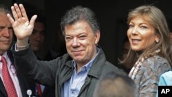 El presidente colombiano Juan Manuel Santos saluda junto a su esposa María Clemencia Rodríguez a su llegada al hospital donde está siendo operado esta mañana de miércoles, para remover un tumor cancerígeno en la próstata.