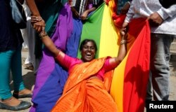 FILE - An LGBT activist celebrates after the Supreme Court's verdict decriminalizing gay sex, in Bengaluru, India, Sept. 6, 2018.
