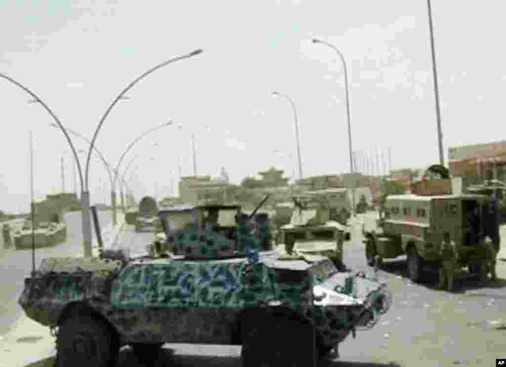 This image taken from video obtained from the Iraqi Military shows armored and military vehicles during clashes in the northern city of Mosul, Iraq, June 9, 2014. 