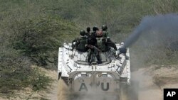 African Union peacekeepers in Somalia patrol in a tank as they assist Somalia government forces during clashes with Islamist insurgents in southern Mogadishu, Somalia, March 9, 2011.