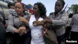 Berta Soler, leader of The Ladies in White, an opposition group, is detained by Cuban security personnel after a weekly anti-government protest march, in Havana, Sept. 13, 2015.