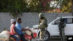 FILE—Soldiers inspect commuters at the entrance of the international airport in Port-au-Prince, Haiti, March 6, 2024.