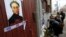 FILE - People lay flowers next to a portrait of slain journalist Anna Politkovskaya near the apartment building where she lived in central Moscow October 7, 2012.