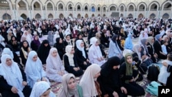 FILE - Muslims perform Eid prayers on the first day of Eid al-Adha holiday at the Sunni shrine of Abdul-Qadir al-Gailani in Baghdad, Iraq, June 28, 2023.