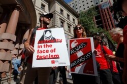 FILE - Protesters gather before a rally by the right-wing Patriot Prayer group in Portland, Ore., Aug. 4, 2018.