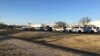 In this photo provided by KWCH-TV, police vehicles line the road after reports of a shooting at an industrial site in Hesston, Kan., Feb. 25, 2016. 