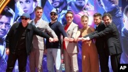 Marvel Studios President Kevin Feige, from left, poses with members of the cast of "Avengers: End Game," Chris Hemsworth, Chris Evans, Robert Downey Jr., Scarlett Johansson, Jeremy Renner and Mark Ruffalo at TCL Chinese Theatre.