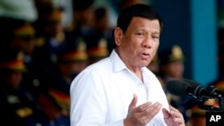 FILE - Philippines President Rodrigo Duterte gestures while addressing the police force to mark the 117th Philippine National Police Service anniversary at Camp Crame in Quezon city northeast of Manila, Aug. 8, 2018.