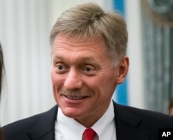 FILE - In this Friday April 6, 2018 file photo, Russian President Vladimir Putin's spokesman Dmitry Peskov smiles after a presentation ceremony for presidential awards to young people in the Kremlin, Moscow, Russia.