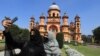 FILE —In this picture taken on March 13, 2024, Muslim girls take their selfie in front of Raza Library at Rampur in India's Uttar Pradesh state.