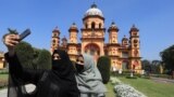 FILE —In this picture taken on March 13, 2024, Muslim girls take their selfie in front of Raza Library at Rampur in India's Uttar Pradesh state.