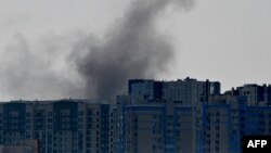 TOPSHOT - Smoke rises over buildings following a Russian attack in Kyiv, on August 26, 2024, amid the Russian invasion of Ukraine.