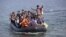 FILE - A dinghy with Syrian and Afghan refugees approaches the Greek island of Lesbos, Sept. 3, 2015. Chile has offered to host families seeking refuge from Syria's civil war.