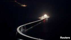 An evening view of the Hong Kong-Zhuhai-Macau bridge and its entrances to a cross sea tunnel, off Lantau island in Hong Kong, China October 21, 2018, before its opening ceremony on October 23, 2018. 