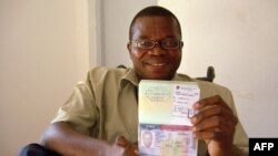 Gabonese opposition and non-government organization member Marc Ona Essangui shows on June 8, 2008 his passport, featuring an exit date and a boarding pass. 