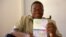 Gabonese opposition and non-government organization member Marc Ona Essangui shows on June 8, 2008 his passport, featuring an exit date and a boarding pass. 