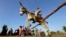 Egyptian farmer Ahmed Ayman, 14, rides his trained donkey as he jumps over a barrier in the Nile Delta village of Al-Arid about 150 kilometers north of Cairo, Egypt, Feb. 5, 2016.
