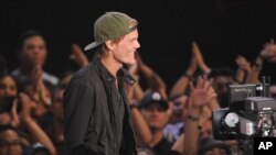 FILE - Avicii accepts the award for EDM song of the year at the iHeartRadio Music Awards at the Shrine Auditorium, May 1, 2014, in Los Angeles. 