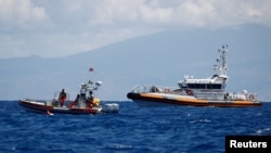 FILE - Italian Coast Guard boats are seen in the waters off Sicily, Aug. 21, 2024.