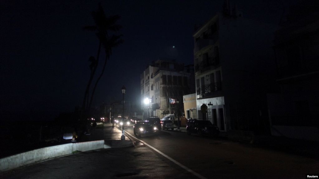 Cars drive on a street in the light of a generator-powered lamp set up by the municipality, after Hurricane Maria hit the island and damaged the power grid in September, in Old San Juan, Puerto Rico Oct. 26, 2017.