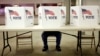 A voter casts a ballot at the Flushing Volunteer Fire Department in Flushing, Ohio, March 6, 2012. 