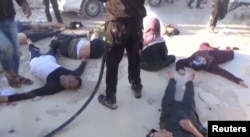 FILE - A still image taken from a video posted to a social media website on April 4, 2017, shows people lying on the ground, said to be in the town of Khan Sheikhoun, after what rescue workers described as a suspected gas attack in rebel-held Idlib, Syria.
