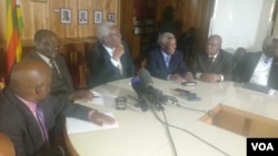 Ignatius Chombo and other state officials addressing the press in Harare on Tuesday.