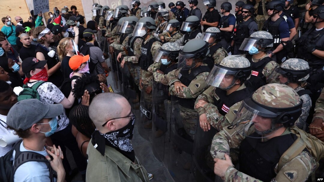 Demonstrators stand in front of D.C. National Guard and other law law enforcement officers during a peaceful protest against police brutality and the death of George Floyd, on June 3, 2020 in Washington, D.C. 
