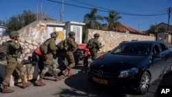 Israeli soldiers patrol the perimeter of the agricultural settlement of Avivim, next to the Lebanese border, in upper Galilee, Israel, Dec. 2, 2024.