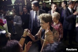 FILE - Brazil's President Dilma Rousseff greets women during a rally in support of her and against her impeachment in front of Planalto Palace in Brasilia, April 19, 2016.