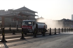 A truck sprays disinfectant on street in Xi'an in China's northern Shaanxi province, Dec. 31, 2021, amid a Covid-19 lockdown.