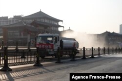 A truck sprays disinfectant on street in Xi'an in China's northern Shaanxi province, Dec. 31, 2021, amid a Covid-19 lockdown.