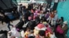 Venezuelan migrants wait for a bus in Bogota, Colombia, July 2, 2020, to travel to the border. Facing no work due to the COVID-19-related economic shutdown, hundreds of Venezuelan migrants are returning to their country.