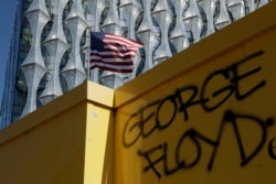 George Floyd's name is written outside the U.S. embassy after people marched there from Trafalgar Square in central London on Sunday, May 31, 2020, to protest against the recent killing of George Floyd in Minneapolis.