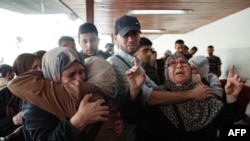 People mourn relatives killed in an Israeli strike that targeted areas in the northern Gaza Strip, in front of the al-Maamadani hospital on October 31, 2024, amid the ongoing war between Israel and Hamas militants.