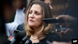 Canadian Foreign Affairs Minister Chrystia Freeland speaks to the media as she arrives at the Office of the United States Trade Representative, Sept. 11, 2018, in Washington. 