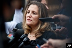 Canadian Foreign Affairs Minister Chrystia Freeland speaks to the media as she arrives at the Office of the United States Trade Representative, Sept. 11, 2018, in Washington.