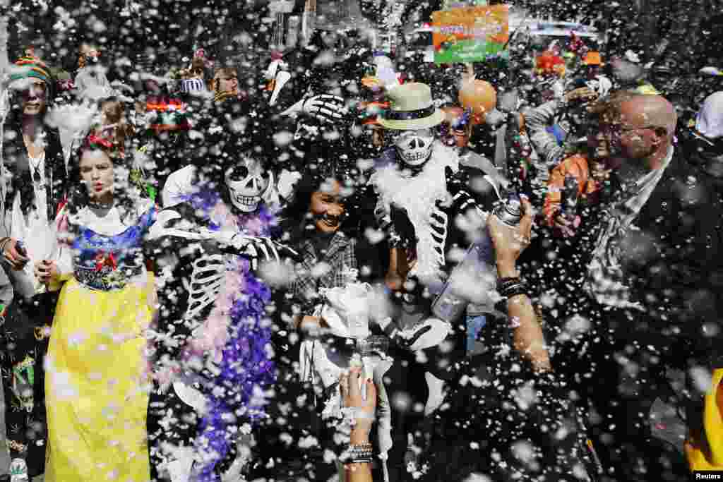 Revelers in costumes are sprayed with foam during a parade for the Jewish holiday of Purim outside Bialik Rogozin school in south Tel Aviv, Israel. Purim is a celebration of the Jews&#39; salvation from genocide in ancient Persia, as recounted in the Book of Esther.