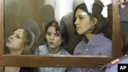 Members of punk group Pussy Riot on trial in glass-enclosed courtroom cage, Moscow, July 30, 2012.